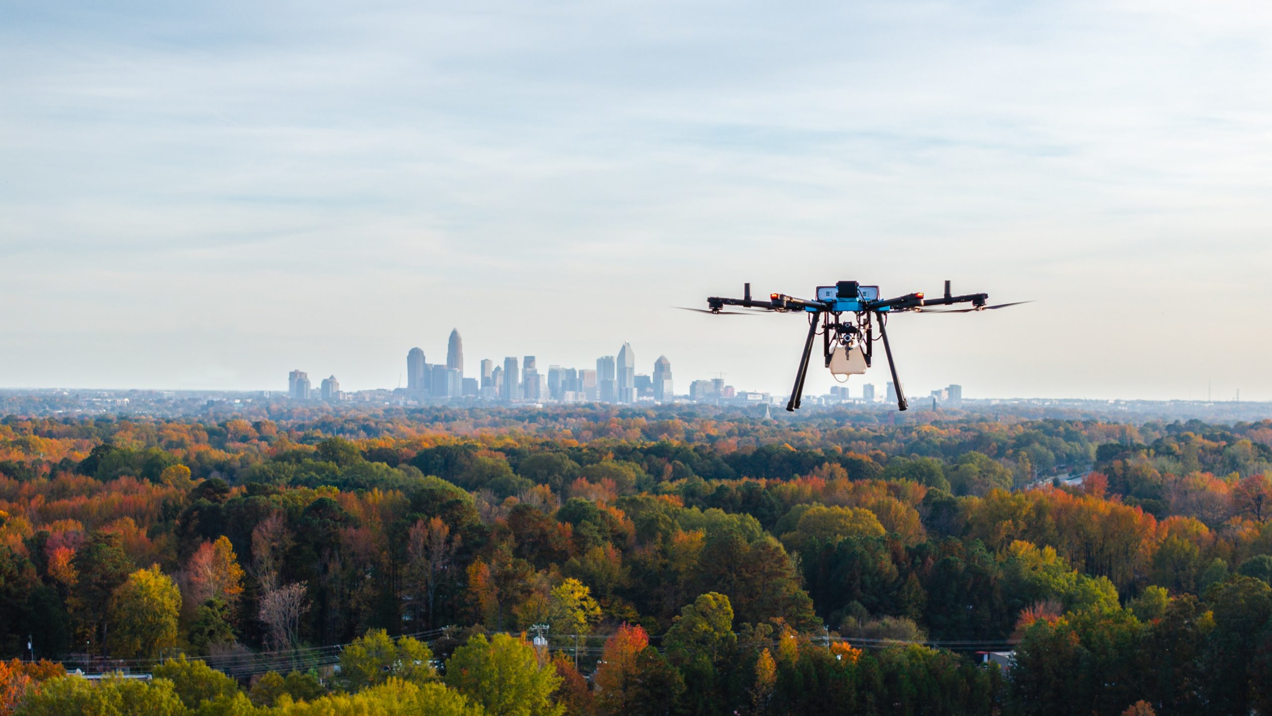 Drone power washing a surface with water spray.